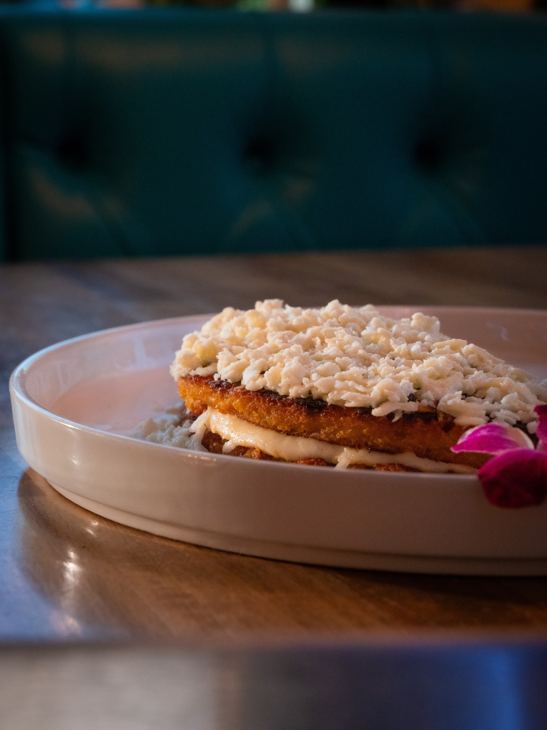 Stuffed cachapa plated at a restaurant, photographed by La Camera